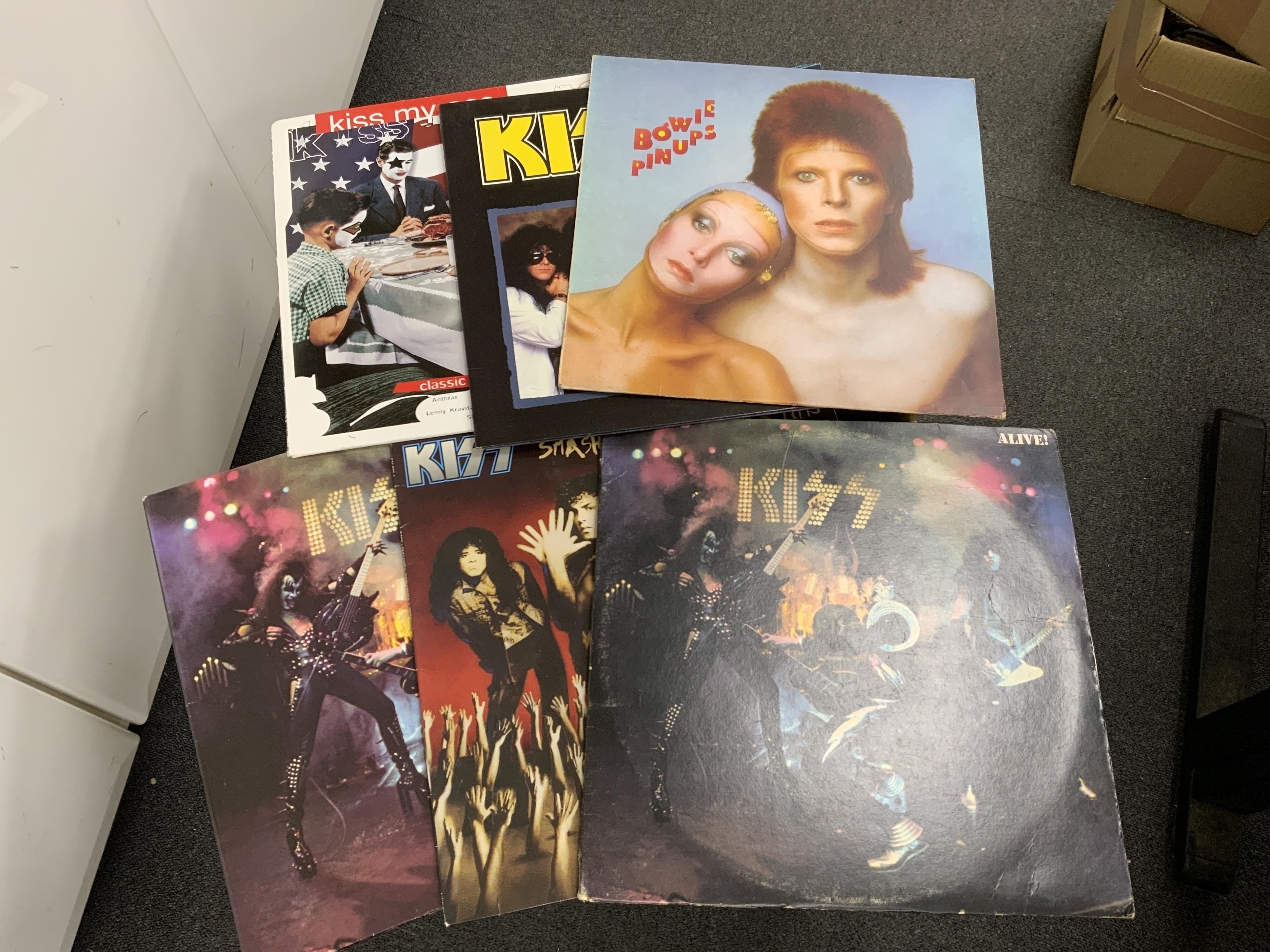 Fifty-six LP record albums, 12” singles, compilations and soundtracks, artists including; Poison, David Bowie, Kiss, Led Zeppelin, INXS, etc. Condition - fair to good